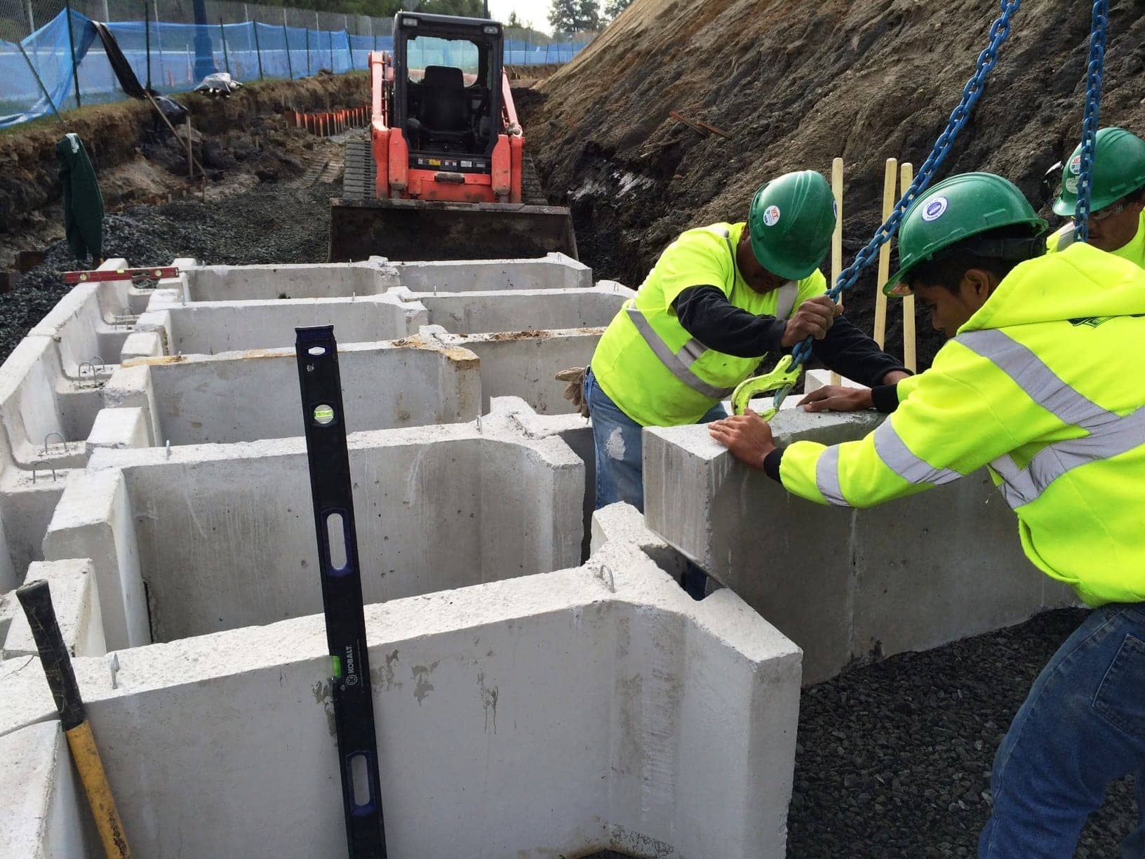Installers build MagnumStone retaining wall with gravity extenders