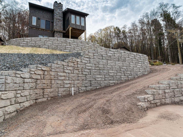 MagnumStone gravity and geogrid retaining walls at steep property