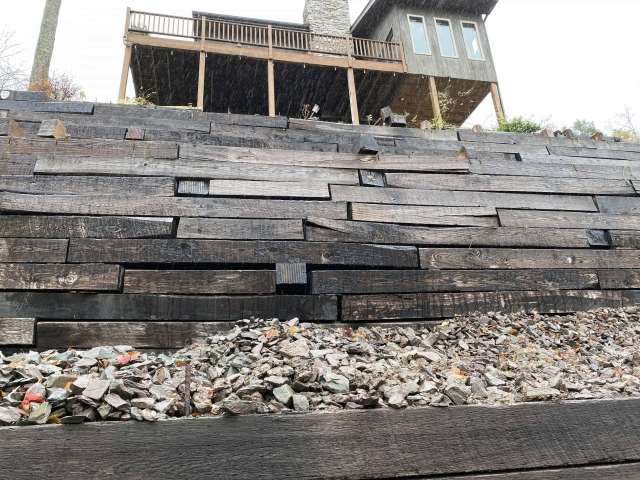 Wooden retaining walls were not designed for pressures of a house