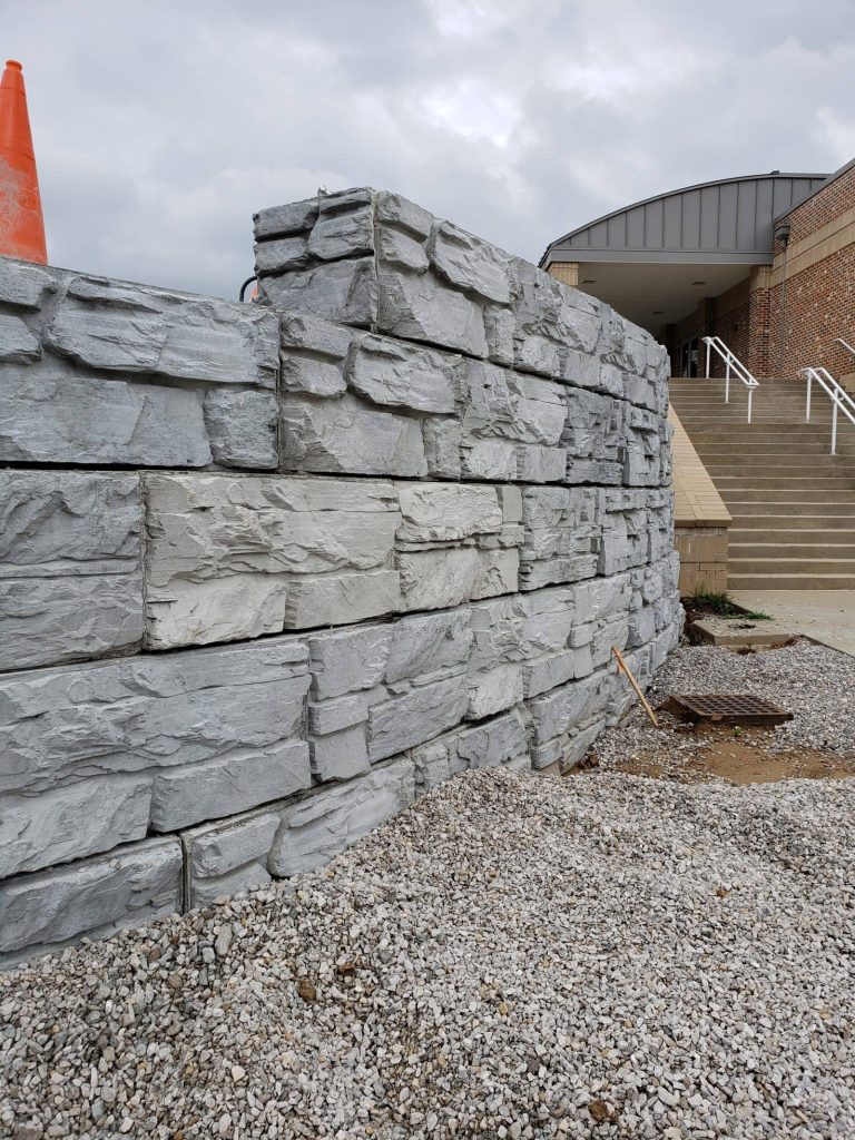Curved MagnumStone wall with step-up feature at the top of the wall. Commercial retaining wall project.