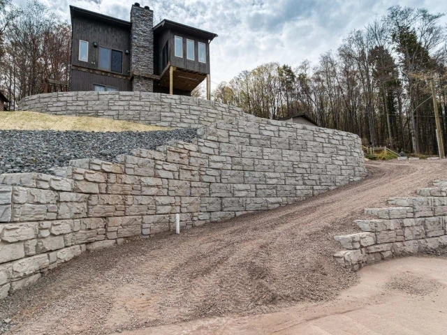 Residential project with sloped, curved driveway walls.