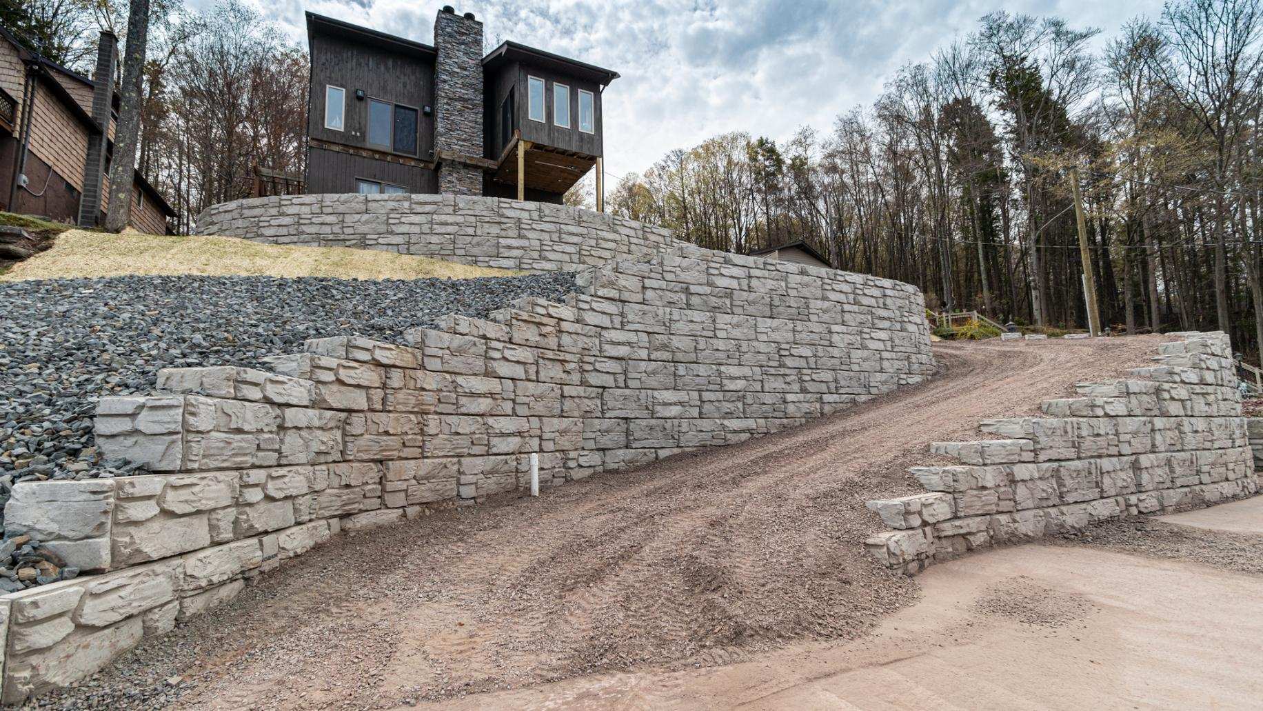 Residential project with sloped, curved driveway walls.