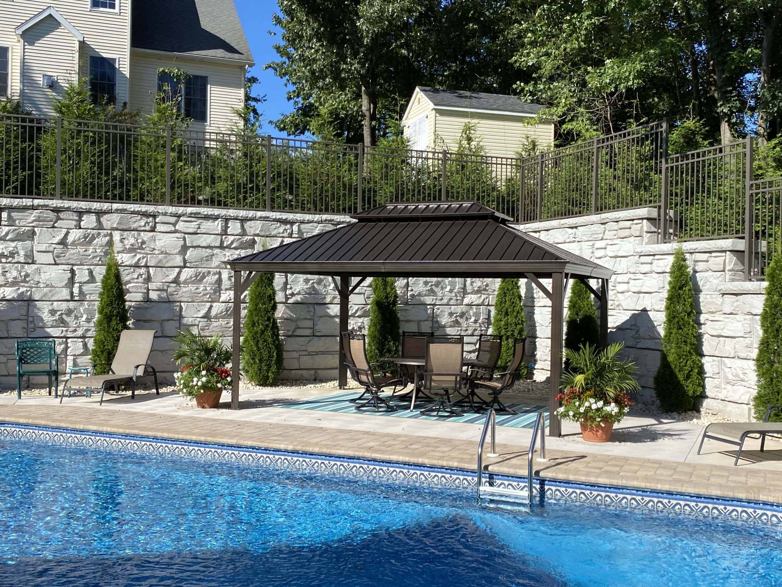 Backyard MagnumStone retaining walls for pool area.