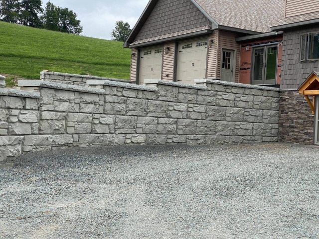Driveway dividing retaining wall for residential garage.