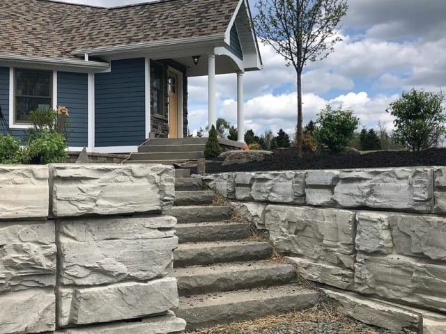 Front yard MagnumStone retaining wall with cap unit steps.