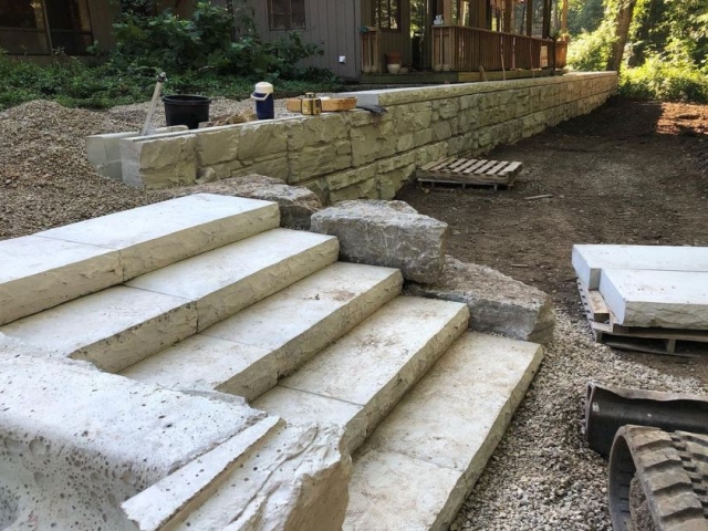 MagnumStone retaining wall installation with cap unit stairs.