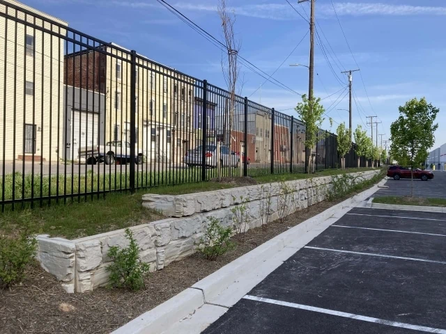 Short parking area retaining wall with fence.
