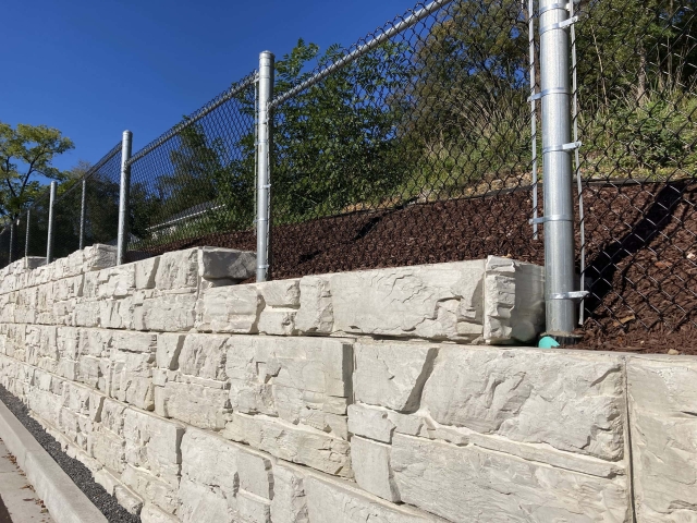 Fence installed in hollow core MagnumStone wall blocks.