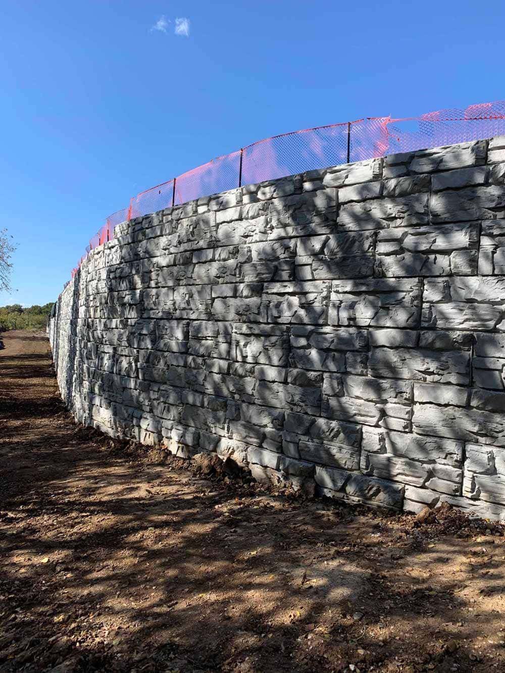 Curved MagnumStone Retaining Wall for Industrial Warehouse.
