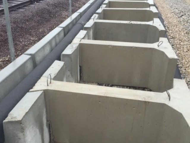 MagnumStone multi-length gravity extenders for railway retaining wall.