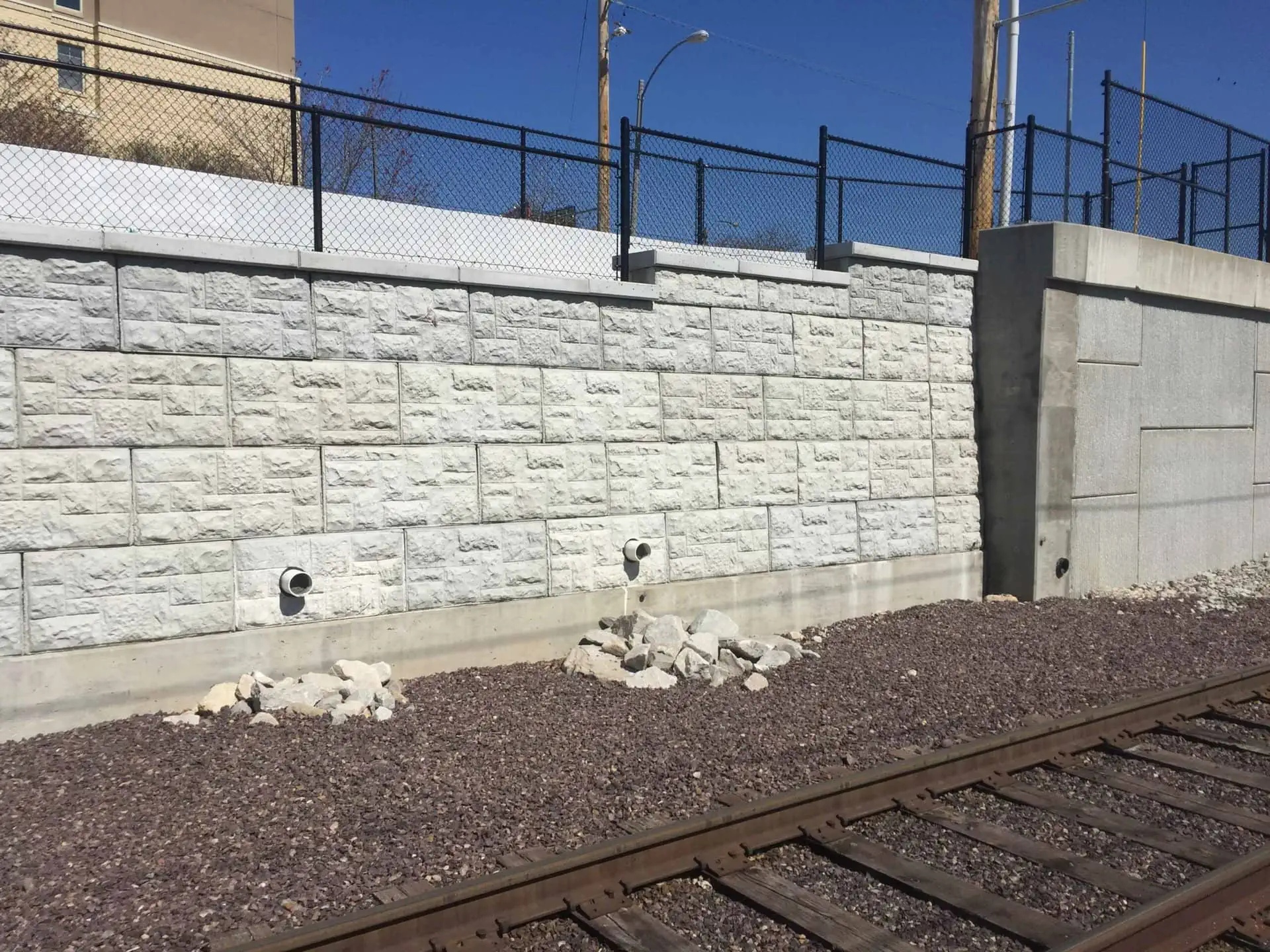 MagnumStone railway retaining wall with through-wall drainage.