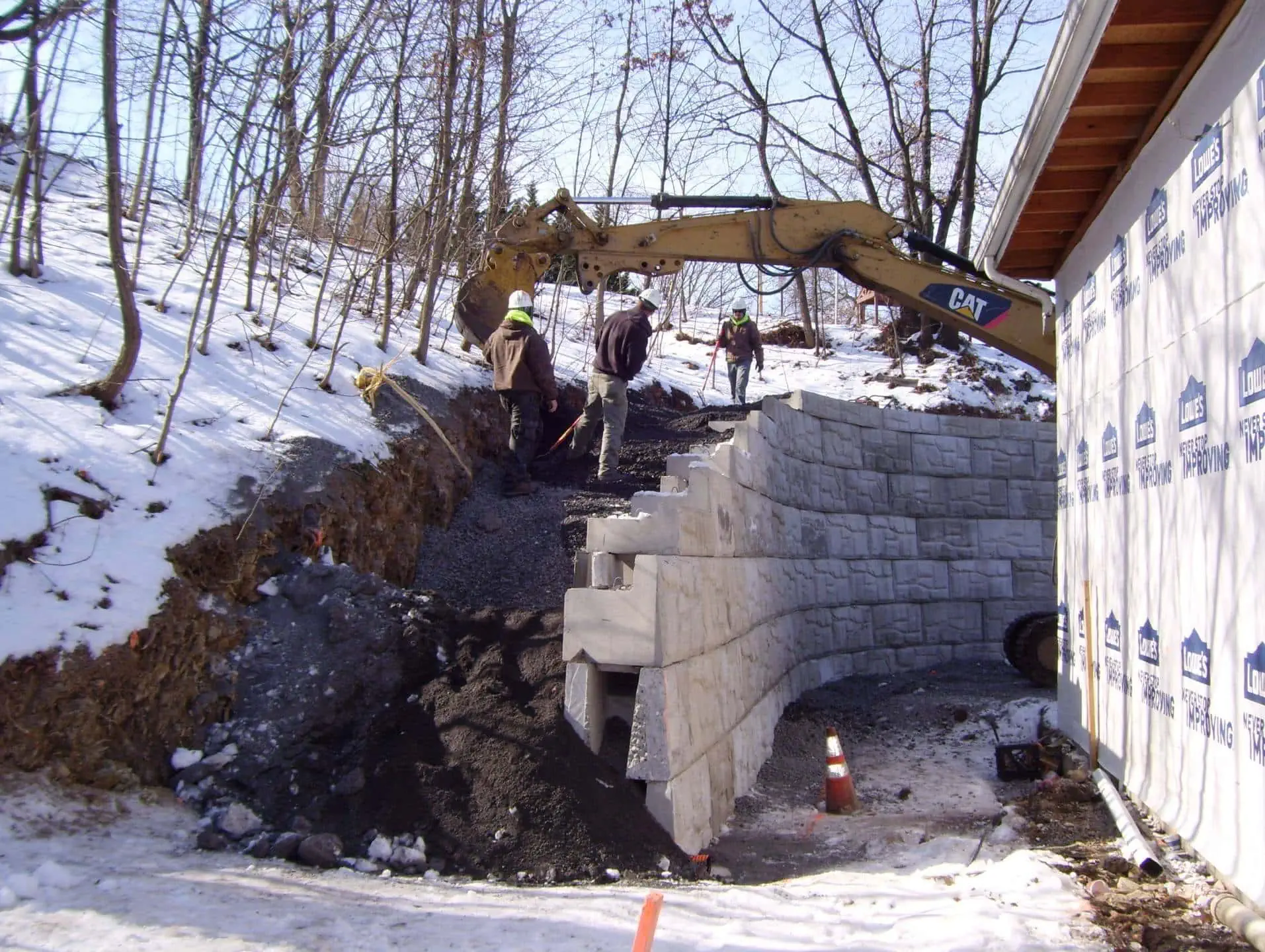 Winter construction of MagnumStone retaining wall.