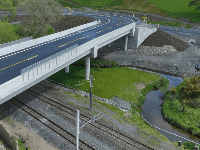 Completed Kopaki bridge with MagnumStone abutments over railroad tracks.