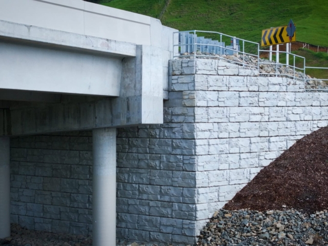 MagnumStone bridge abutments connect to roadway.