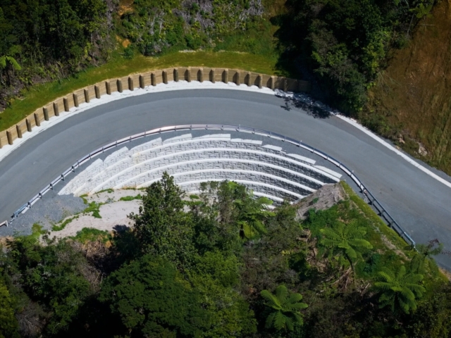 MagnumStone curved retaining wall rebuilds road.