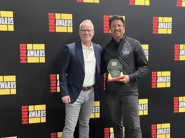 MagnumStone accepts 2025 HNA Commercial Retaining Wall Award.