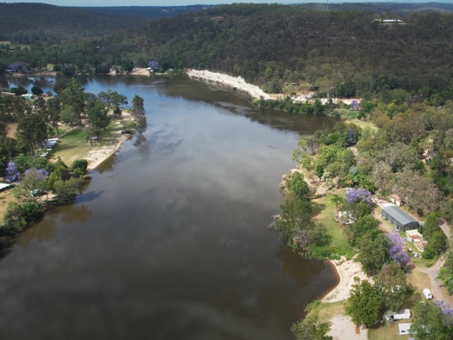 Aerial view of MagnumStone wall construction repairing flooded road.