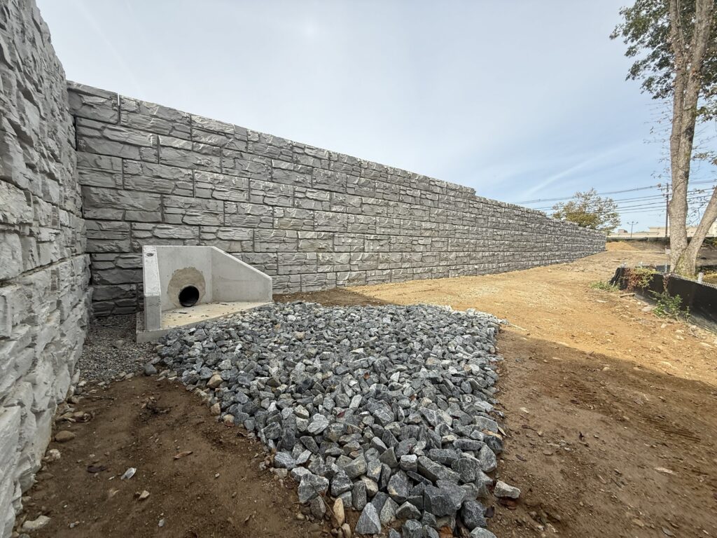 MagnumStone retaining wall with drainage culvert.